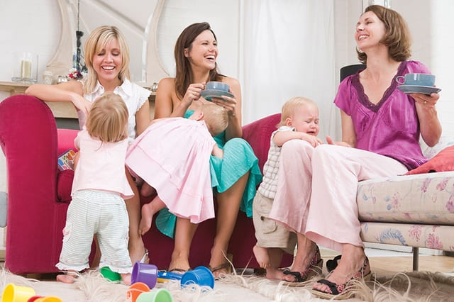 State College - Three mothers in living room with coffee and babies smiling