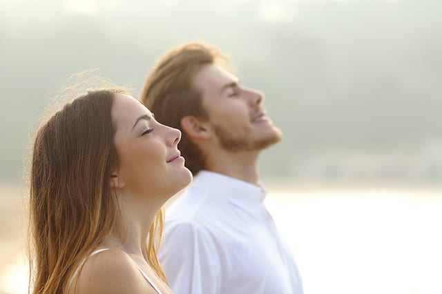 State College - Couple of man and woman breathing deep fresh air