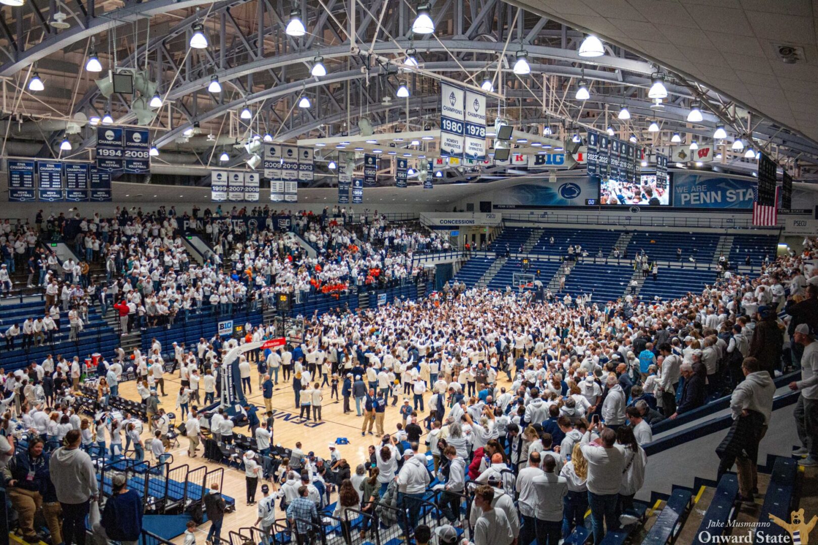 Fans storm the court at Rec Hall after Penn State's 90-89 upset of Illinois on Feb. 21. 2024.