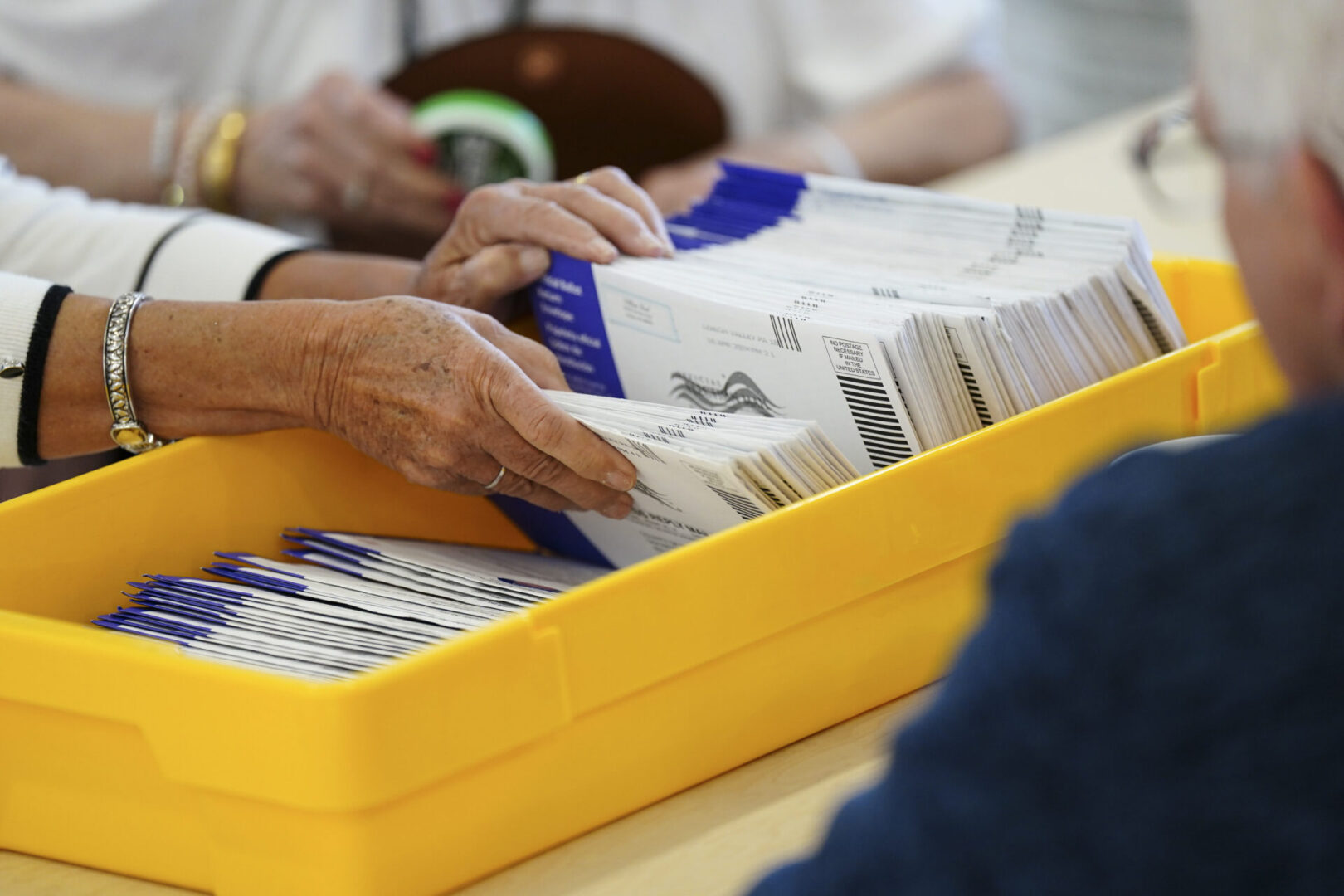 Workers sort mail-in ballots on primary Election Day 2024 at Northampton County Courthouse in Easton.