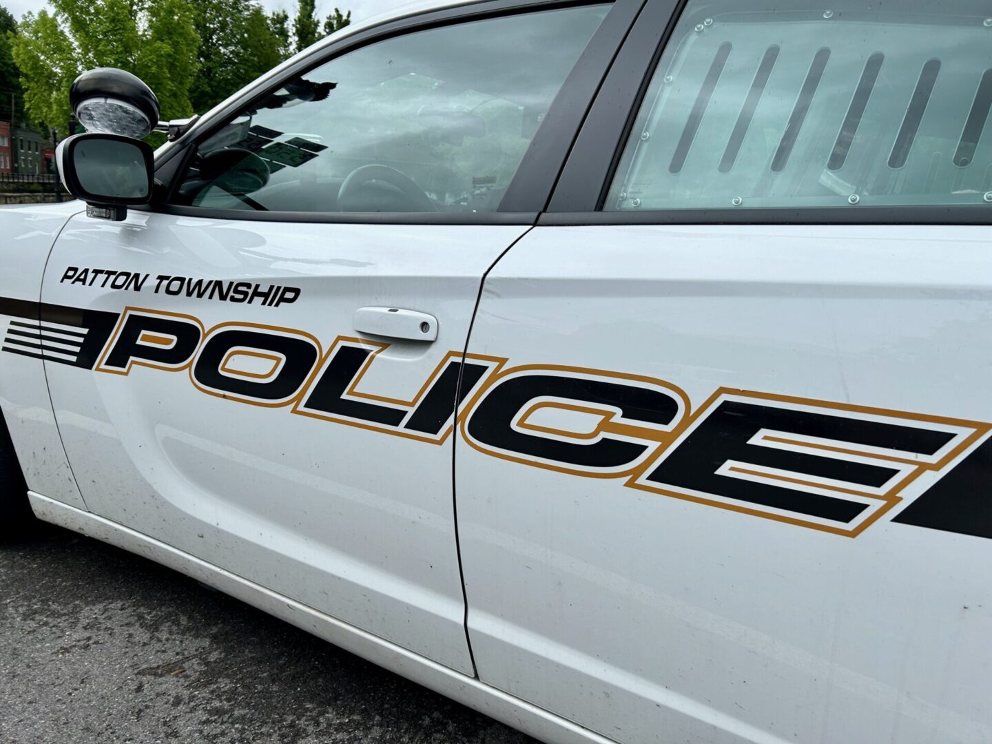 A white police cruiser with Patton Township Police in black and yellow letters