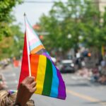 A community member holds up a Progress Pride flag during the 2023 State College Pride celebration