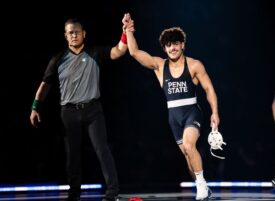 A referee raises Penn State wrestler Beau Bartlett's right arm after Bartlett's win against Iowa at the Bryce Jordan Center